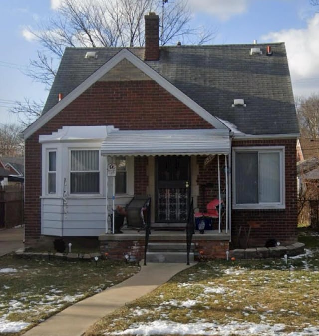 9350 Sanilac St, Detroit, MI 48224 - bungalow with a chimney, brick siding, roof with shingles, and a porch