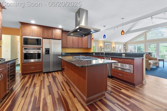 21089 Thorofare Rd, Grosse Ile, MI 48138 - kitchen with appliances with stainless steel finishes, island exhaust hood, track lighting, a peninsula, and a warming drawer