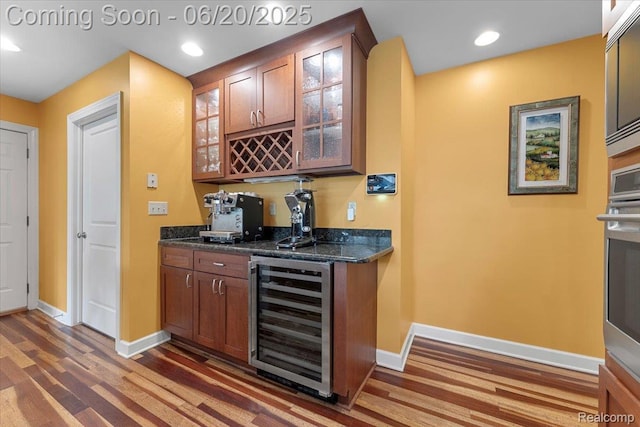 21089 Thorofare Rd, Grosse Ile, MI 48138 - indoor wet bar featuring beverage cooler, wood finished floors, stainless steel oven, and recessed lighting