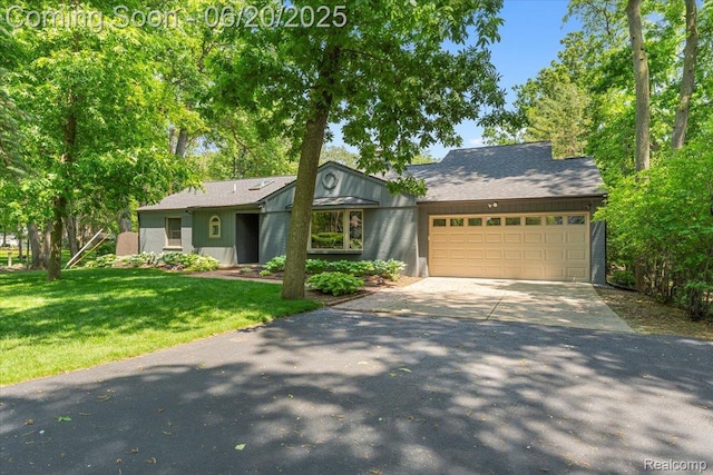 21089 Thorofare Rd, Grosse Ile, MI 48138 - view of front of house with concrete driveway, an attached garage, and a front yard