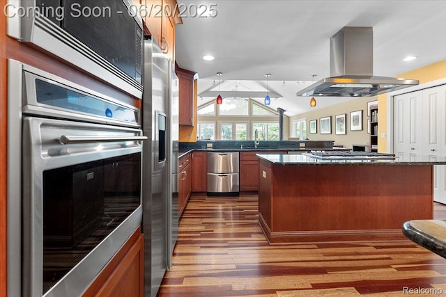 21089 Thorofare Rd, Grosse Ile, MI 48138 - kitchen with stainless steel appliances, island range hood, dark wood-style floors, lofted ceiling, and dark stone countertops