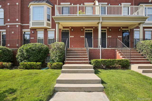 3207 Camden Dr Unit 110, Troy, MI 48084 - view of front of home with brick siding, a porch, a front yard, and a balcony