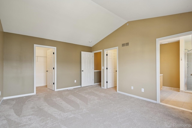 3207 Camden Dr Unit 110, Troy, MI 48084 - unfurnished bedroom featuring a spacious closet, light carpet, lofted ceiling, a closet, and ensuite bath