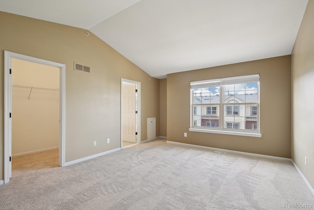 3207 Camden Dr Unit 110, Troy, MI 48084 - unfurnished bedroom with a spacious closet, vaulted ceiling, carpet floors, and a closet