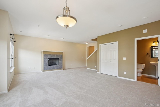 3207 Camden Dr Unit 110, Troy, MI 48084 - unfurnished living room with carpet floors, a tiled fireplace, and healthy amount of natural light