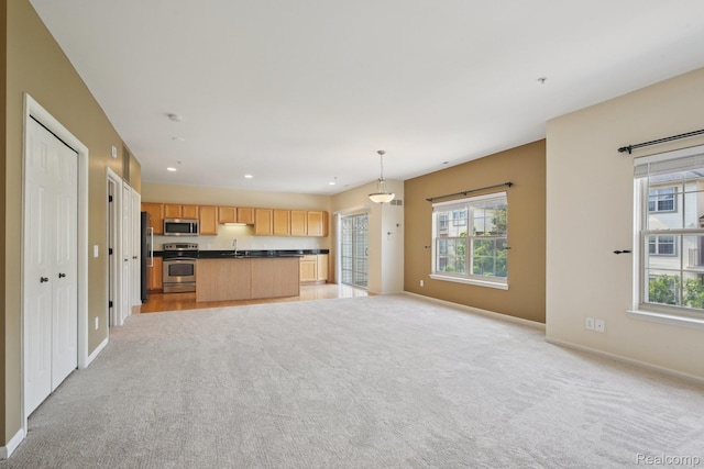 3207 Camden Dr Unit 110, Troy, MI 48084 - kitchen with stainless steel appliances, open floor plan, dark countertops, healthy amount of natural light, and recessed lighting