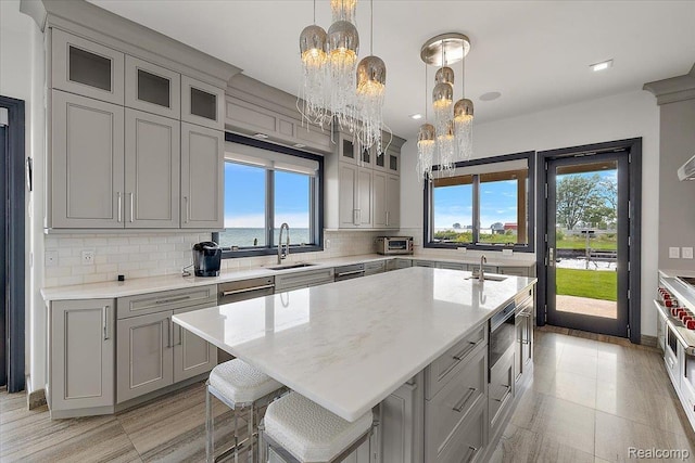 8349 Dixie Hwy, Ira, MI 48023 - kitchen with gray cabinets, plenty of natural light, a chandelier, and backsplash