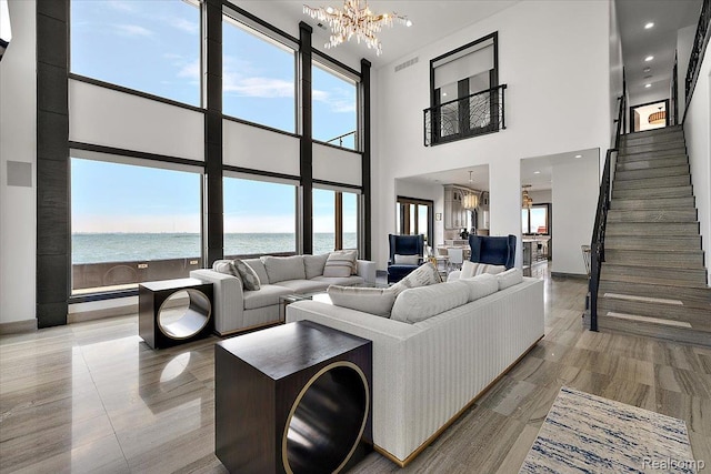 8349 Dixie Hwy, Ira, MI 48023 - living area with a chandelier, a towering ceiling, a water view, and stairway