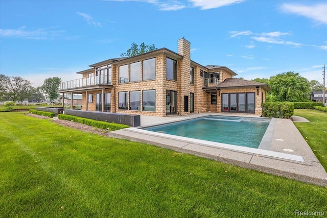 8349 Dixie Hwy, Ira, MI 48023 - back of property with a chimney, a yard, an outdoor pool, and a balcony