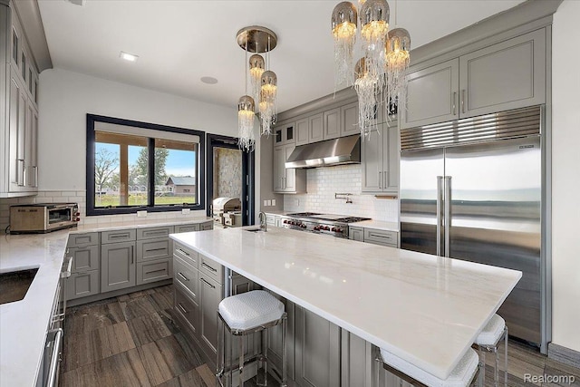 8349 Dixie Hwy, Ira, MI 48023 - kitchen featuring stainless steel built in refrigerator, exhaust hood, gray cabinetry, a chandelier, and tasteful backsplash