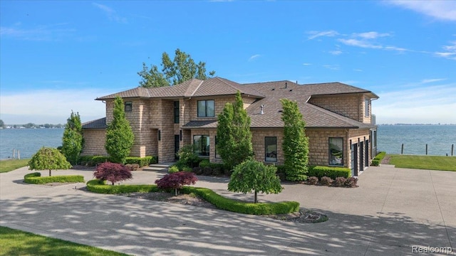 8349 Dixie Hwy, Ira, MI 48023 - view of front of house with a garage, concrete driveway, a water view, and a shingled roof