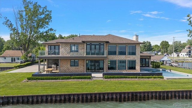 8349 Dixie Hwy, Ira, MI 48023 - back of property featuring a balcony, a chimney, a patio area, stone siding, and a water view