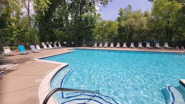 157 E Bay Dr, Walled Lake, MI 48390 - community pool with view of scattered trees and a patio