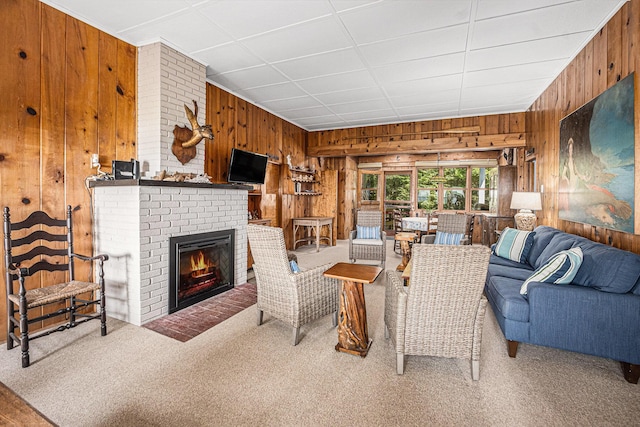 8641 N Perry Ave, Pentwater, MI 49449 - carpeted living area with wood walls and a fireplace