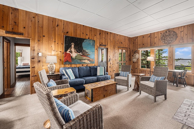 8641 N Perry Ave, Pentwater, MI 49449 - living room featuring healthy amount of natural light, wooden walls, and light carpet