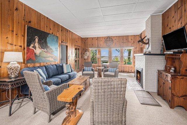 8641 N Perry Ave, Pentwater, MI 49449 - living room with wooden walls, light colored carpet, and a fireplace