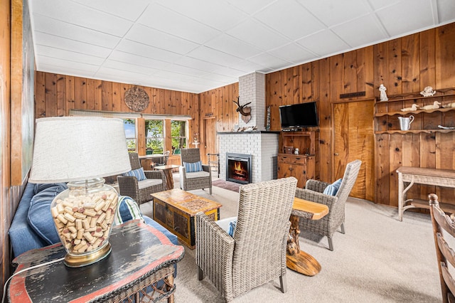 8641 N Perry Ave, Pentwater, MI 49449 - living room with wooden walls, carpet floors, and a fireplace