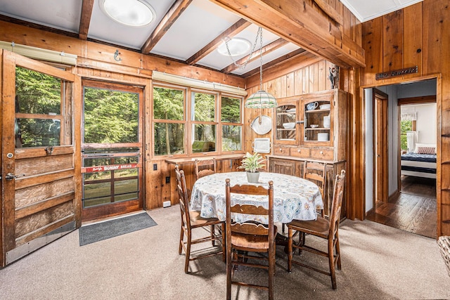 8641 N Perry Ave, Pentwater, MI 49449 - dining area featuring wood walls and light carpet