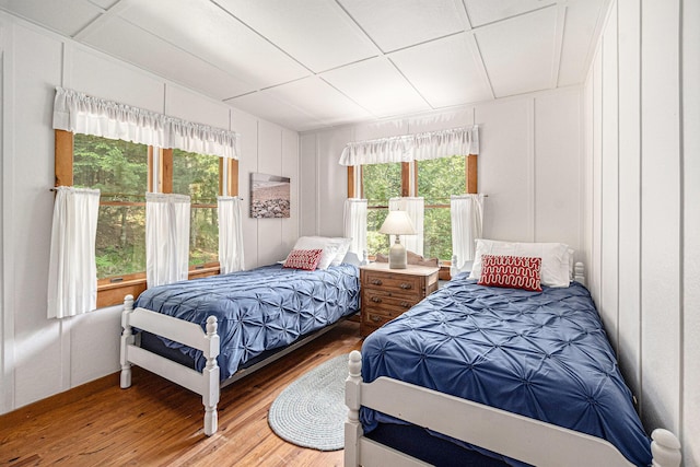 8641 N Perry Ave, Pentwater, MI 49449 - bedroom featuring a decorative wall and wood finished floors