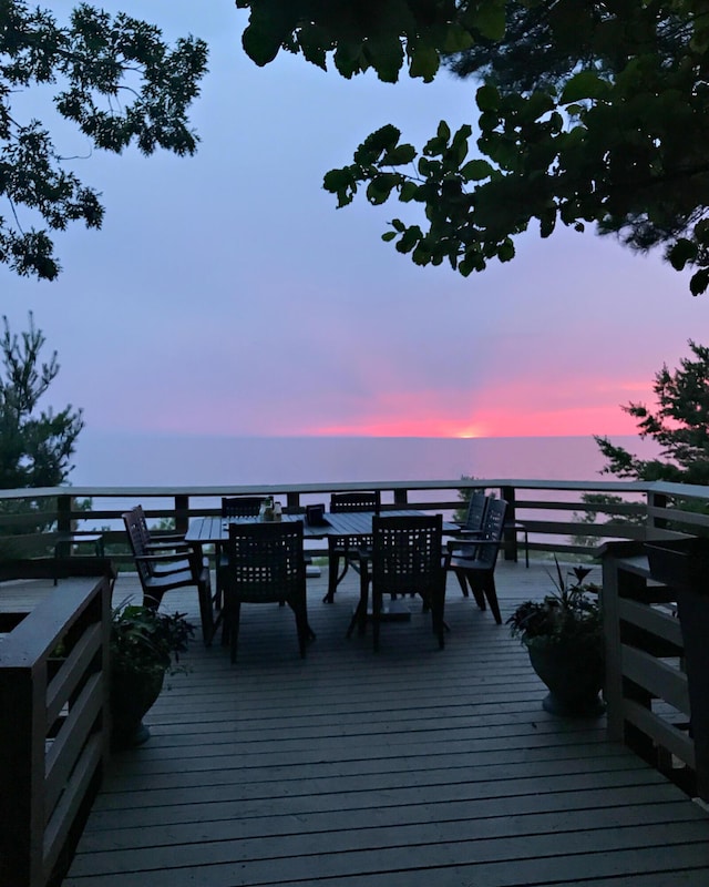 8641 N Perry Ave, Pentwater, MI 49449 - deck at dusk featuring outdoor dining space