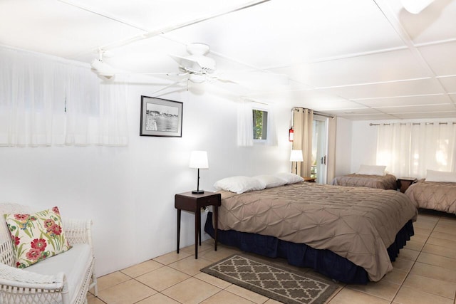 8641 N Perry Ave, Pentwater, MI 49449 - bedroom with light tile patterned floors and a ceiling fan