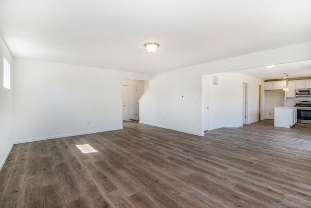 5698 Landrum Trl, Portage, MI 49024 - unfurnished living room featuring dark wood-style floors and baseboards