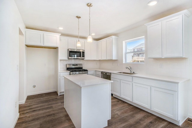5698 Landrum Trl, Portage, MI 49024 - kitchen with stainless steel appliances, decorative backsplash, white cabinetry, dark wood-type flooring, and recessed lighting