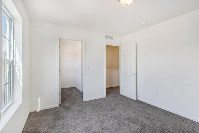5698 Landrum Trl, Portage, MI 49024 - unfurnished bedroom with carpet flooring, a walk in closet, and a closet