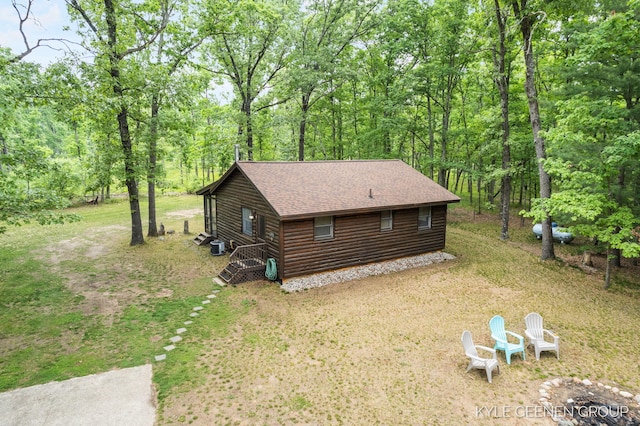 9210/9228 S Star Lake Dr, Baldwin, MI 49304 - view of side of home featuring roof with shingles, a forest view, and log veneer siding