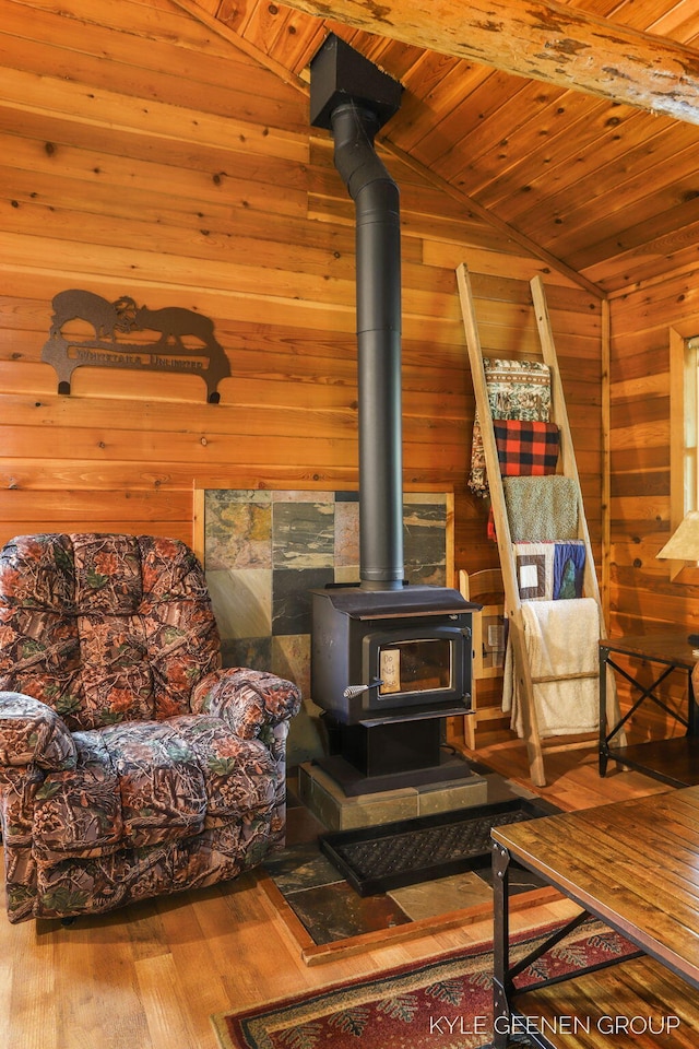 9210/9228 S Star Lake Dr, Baldwin, MI 49304 - living area with a wood stove, wood ceiling, wood walls, wood finished floors, and vaulted ceiling
