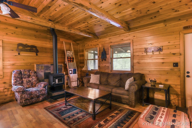 9210/9228 S Star Lake Dr, Baldwin, MI 49304 - living room featuring wood ceiling, a wood stove, wood walls, hardwood / wood-style flooring, and a ceiling fan