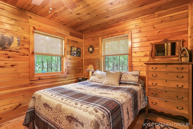 9210/9228 S Star Lake Dr, Baldwin, MI 49304 - bedroom featuring multiple windows, wood finished floors, wooden ceiling, and wood walls
