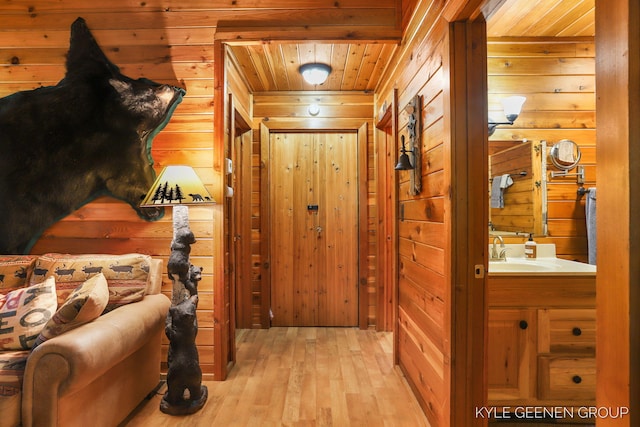 9210/9228 S Star Lake Dr, Baldwin, MI 49304 - hall with wood walls, wood ceiling, and light wood-style floors