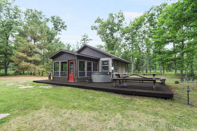 9210/9228 S Star Lake Dr, Baldwin, MI 49304 - back of property featuring a hot tub, a wooden deck, and a yard