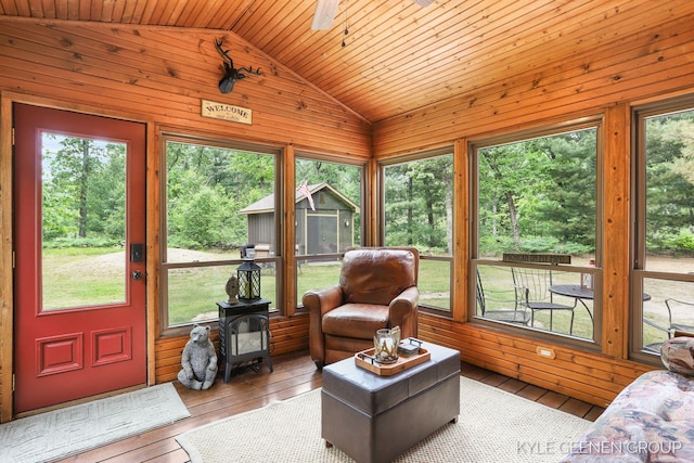 9210/9228 S Star Lake Dr, Baldwin, MI 49304 - living room featuring a wood stove, lofted ceiling, wooden walls, hardwood / wood-style flooring, and wood ceiling