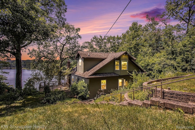 332 Community Dr, Battle Creek, MI 49014 - view of front of house featuring a water view and roof with shingles