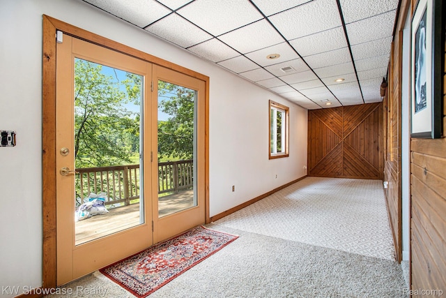 332 Community Dr, Battle Creek, MI 49014 - entryway featuring carpet flooring and wood walls
