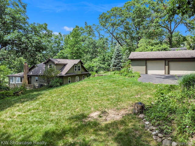 332 Community Dr, Battle Creek, MI 49014 - view of grassy yard with a garage