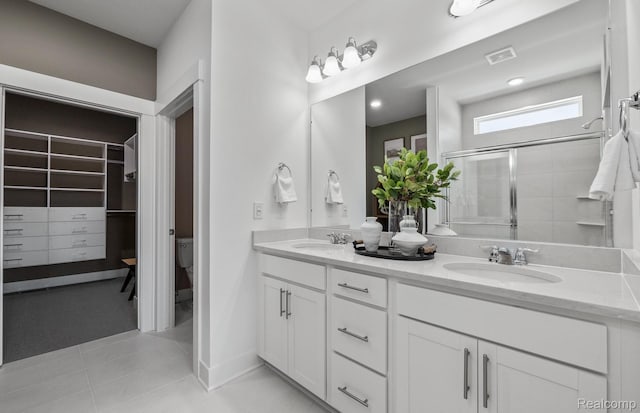 50260 Cromwell St, Canton, MI 48188 - full bathroom featuring double vanity, tiled shower, tile patterned floors, and a spacious closet