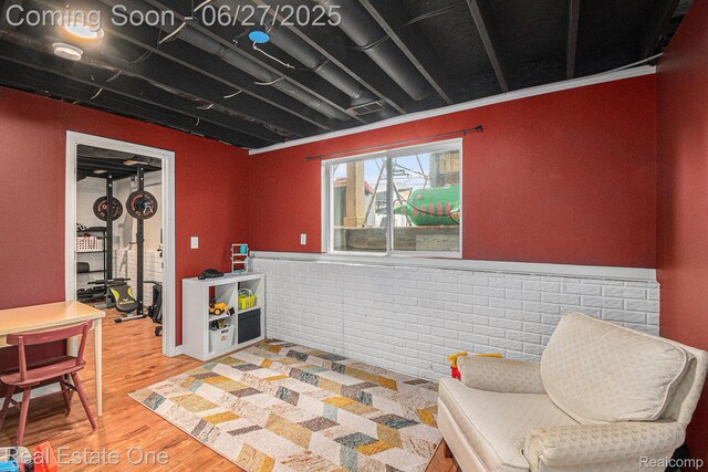 367 Otter Run Rd, Holly, MI 48442 - living area with light wood-style flooring and brick wall