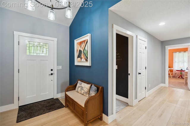 11852 Rathbun Rd, Birch Run, MI 48415 - entryway with light wood-type flooring and a chandelier