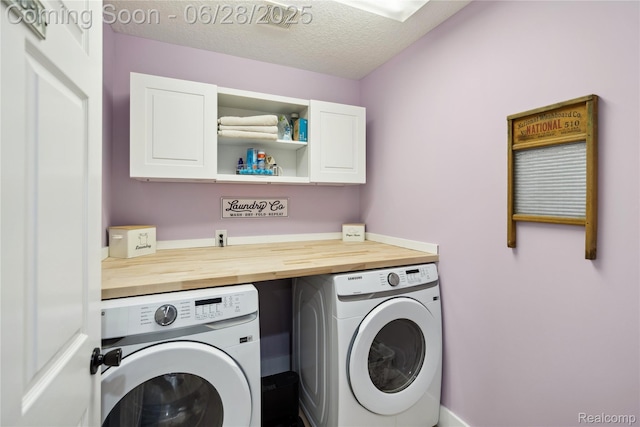 11852 Rathbun Rd, Birch Run, MI 48415 - washroom featuring separate washer and dryer, cabinet space, and a textured ceiling