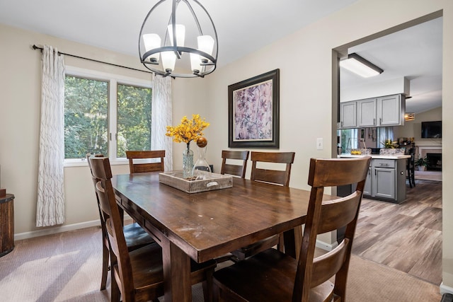 2062 Wildwood Trl, Saline, MI 48176 - dining area featuring a chandelier and light wood-style flooring