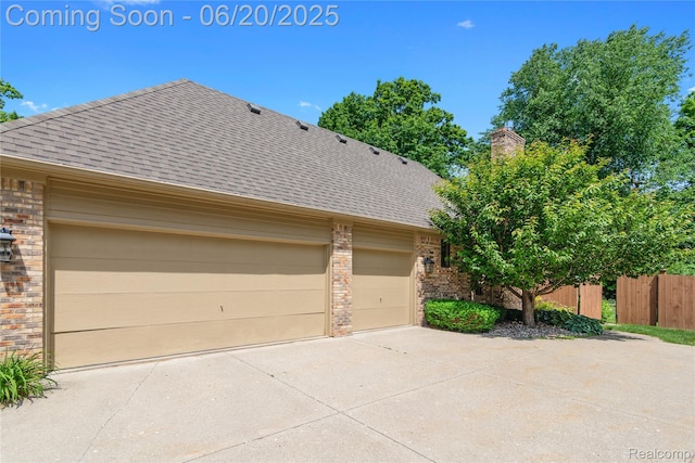1484 Kings Pointe Rd, Grand Blanc, MI 48439 - view of property exterior with brick siding, a shingled roof, and concrete driveway