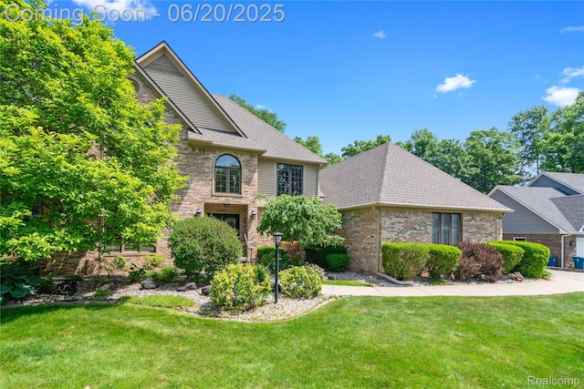 1484 Kings Pointe Rd, Grand Blanc, MI 48439 - traditional-style house with a front yard, brick siding, and roof with shingles