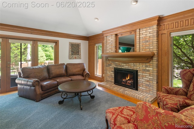1484 Kings Pointe Rd, Grand Blanc, MI 48439 - living area featuring vaulted ceiling, a brick fireplace, and wood finished floors