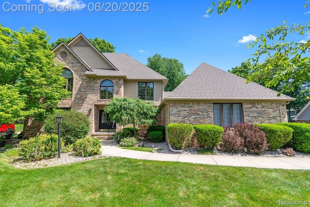 1484 Kings Pointe Rd, Grand Blanc, MI 48439 - view of front of property with brick siding, a front yard, and a shingled roof