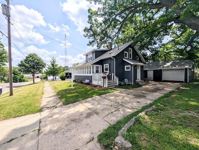 128 E Walnut St, Hastings, MI 49058 - view of front of house with asphalt driveway, an outbuilding, a front lawn, a chimney, and a detached garage