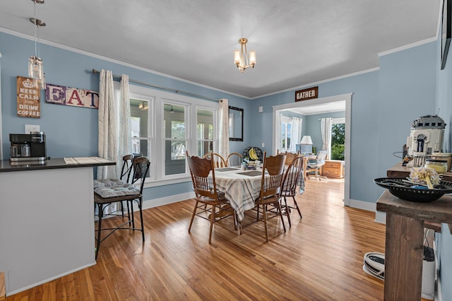 128 E Walnut St, Hastings, MI 49058 - dining space featuring light wood-style flooring, a chandelier, and ornamental molding