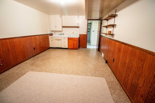 5774 N Wayne Ave, Pentwater, MI 49449 - kitchen featuring a wainscoted wall, wood walls, white cabinetry, open shelves, and brown cabinets